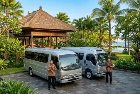 Two Van 15 Seats Bali vehicles parked at a resort parking lot with two friendly drivers standing ready to welcome tourists.