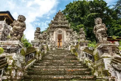 Kehen temple entrance with carved stone stairs and statues