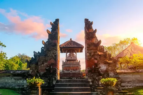 Grand stone Candi Bentar gateway showcasing detailed Balinese carvings inside Taman Ayun Temple.