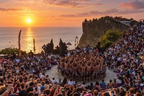 Kecak dancers performing at Uluwatu Temple during a golden sunset
