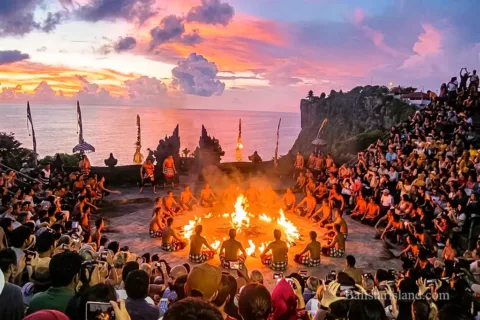 Performers executing the traditional Kecak Fire Dance at the open-air amphitheater in Uluwatu Temple.