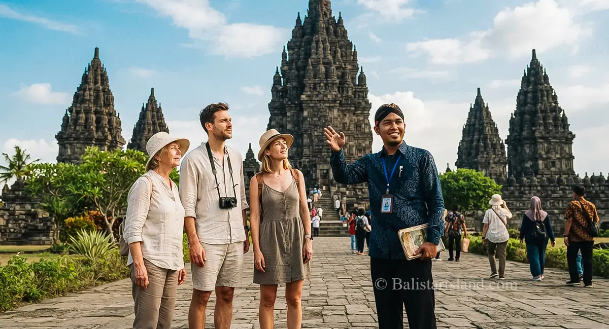 Local tour guide explaining historical features to foreign tourists in front of Prambanan Temple during Central Java Tours.