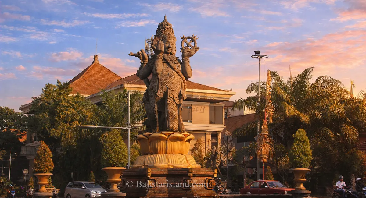 Detailed view of the majestic Catur Muka stone statue monument in downtown Denpasar City.