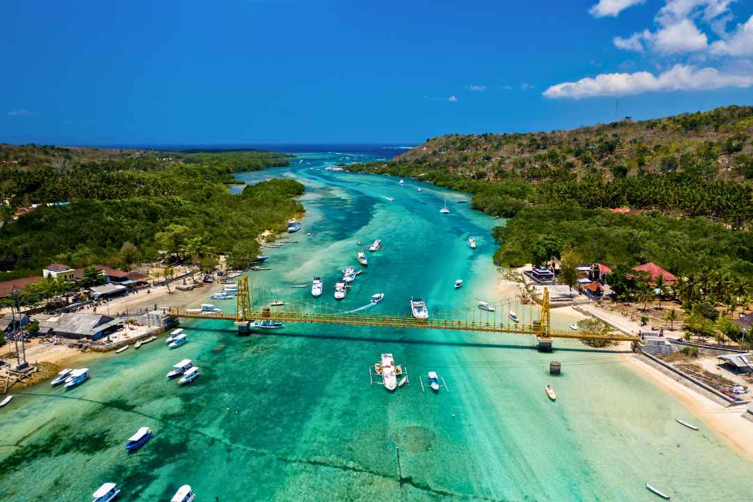 Nusa Lembongan coastal waters with boats and Yellow Bridge in Bali