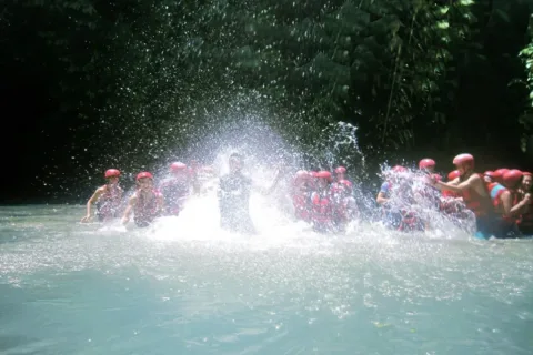 Rafters splashing water and having fun together during an Ayung River Rafting trip