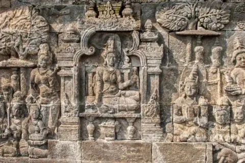 Close-up of detailed Buddhist stone reliefs carved into the walls of Borobudur Temple