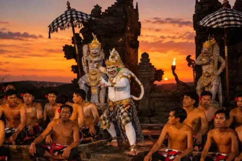 Kecak dancers performing beside temple statues during sunset