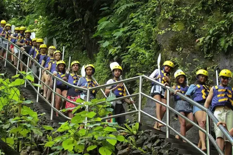 Group of tourists walking down the stairs to the Mason Adventures Rafting start point