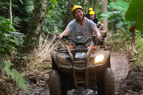 ATV rider tackling muddy terrain during an exciting Pertiwi Quad Bike Adventure