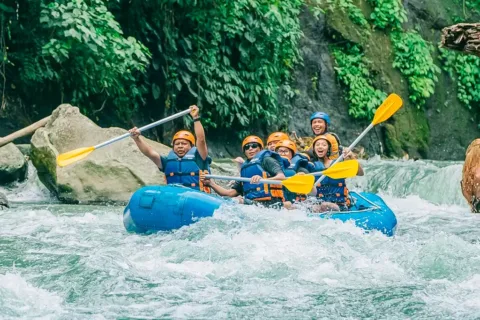 Happy tourists after navigating Class II rapids during Sobek Bali Rafting on the Ayung River