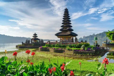 Ulun Danu Beratan Temple surrounded by a calm lake and mountain scenery
