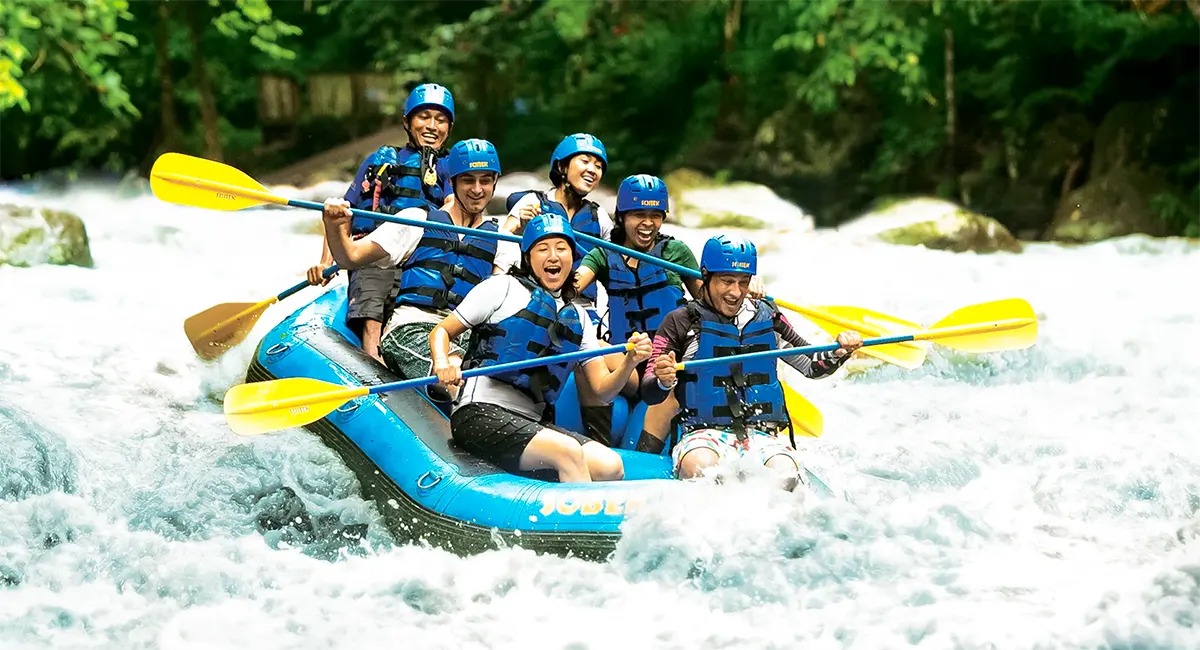 Adventurers navigating challenging rapids during Sobek Bali Rafting on the Ayung River
